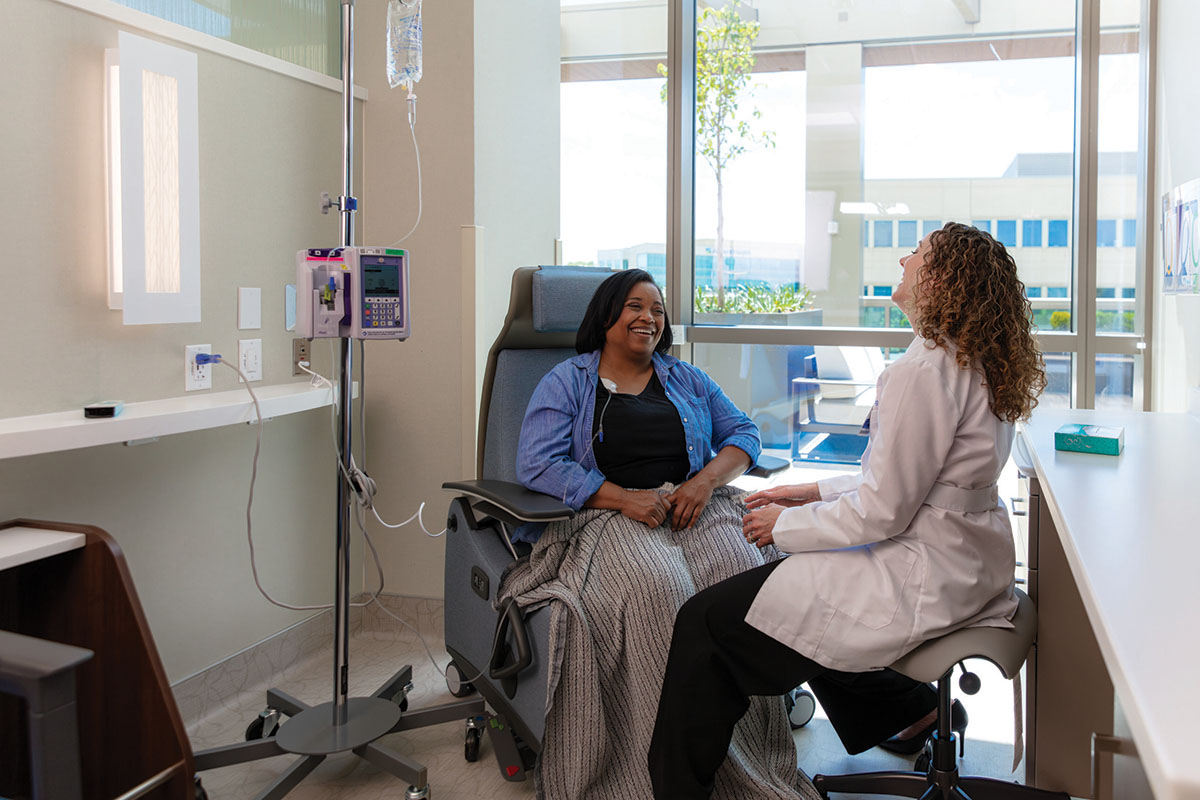 A doctor and patient sitting together and talking.