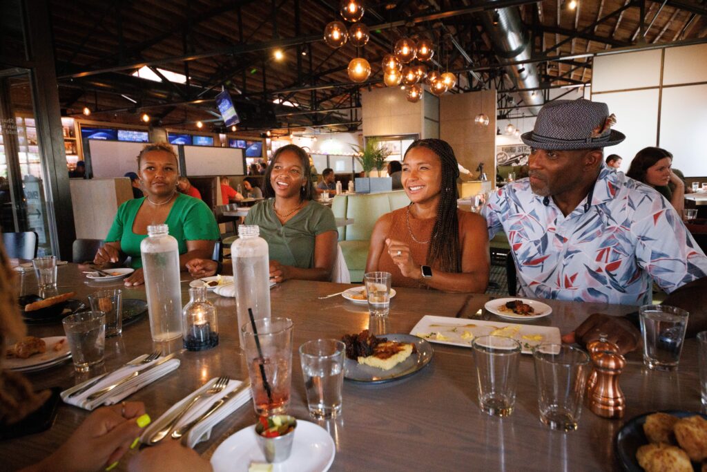 Danan Hughes and his family sitting around a table at Third Street Social.