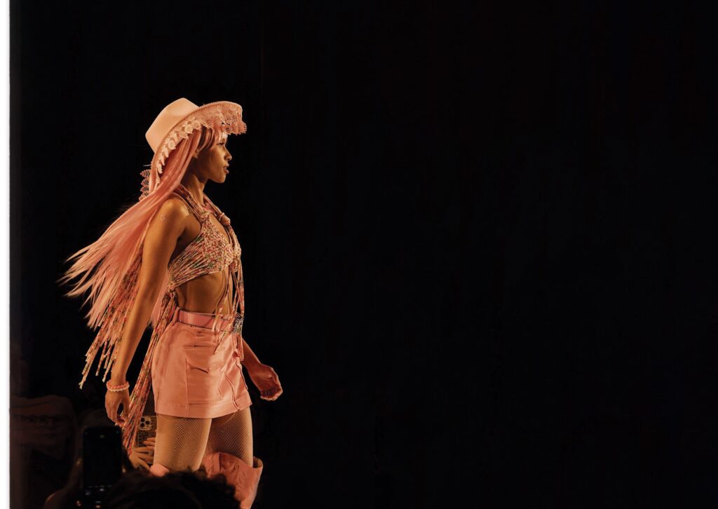 Model walking the runway at KC Fashion Week.