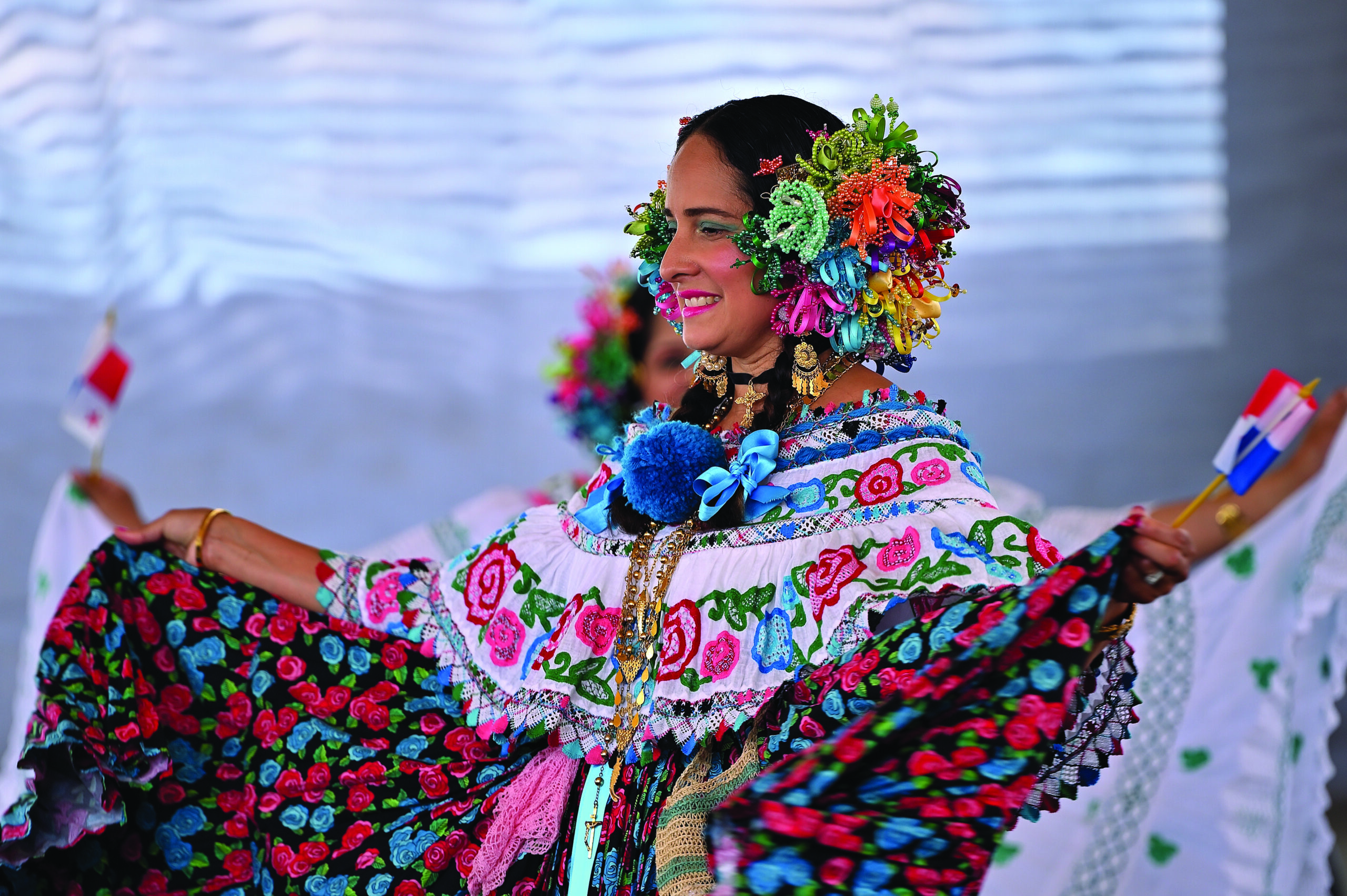 A woman in a colorful dress dances at the Ethnic Enrichment Festival.