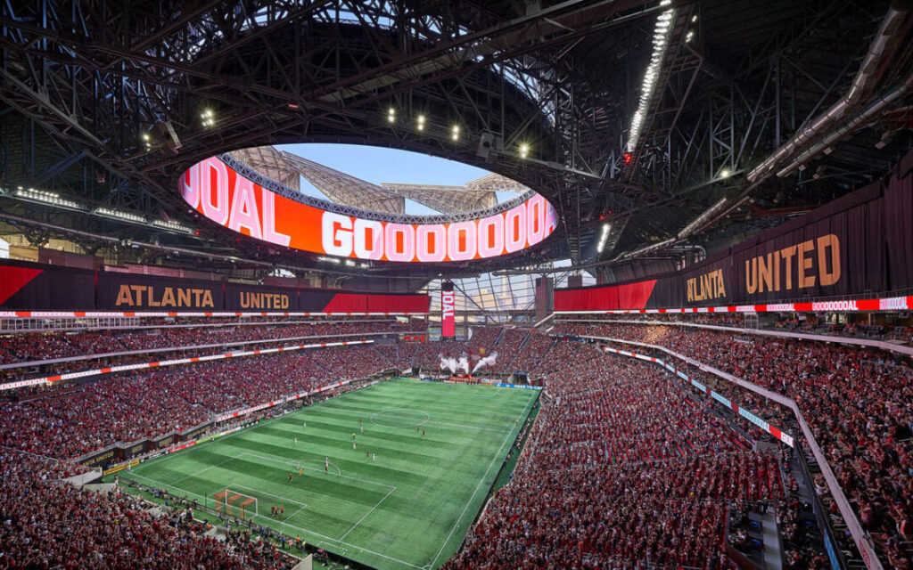 Packed soccer stadium with Atlanta United on digital boards