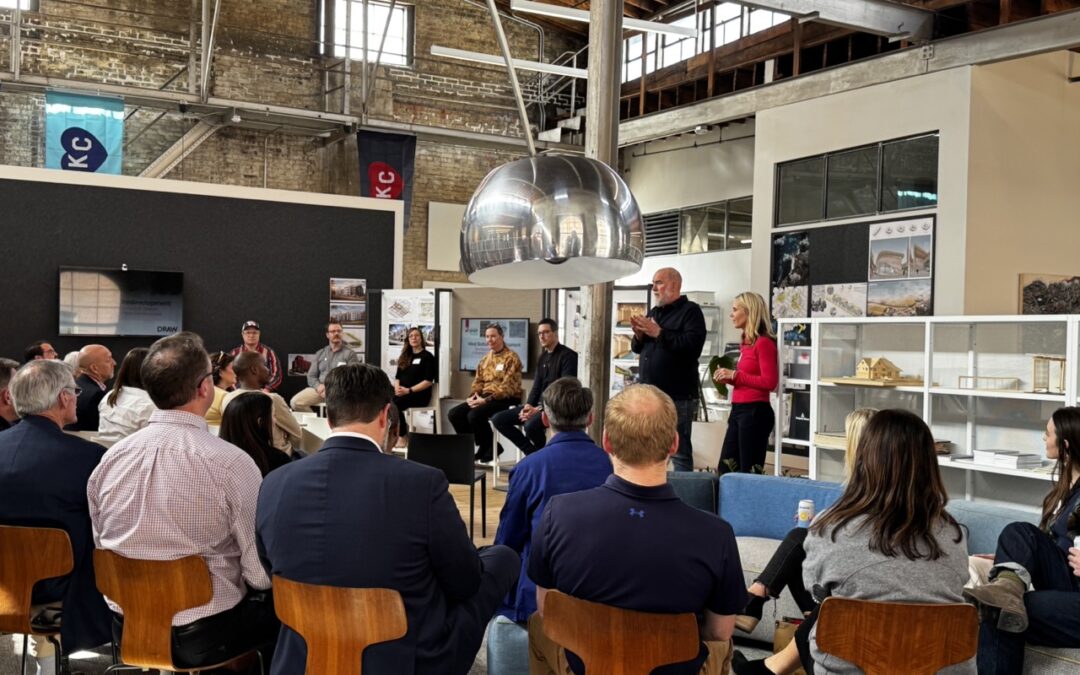 Presenter Discusses the West Bottoms redevelopment in front of a crowd of people in chairs