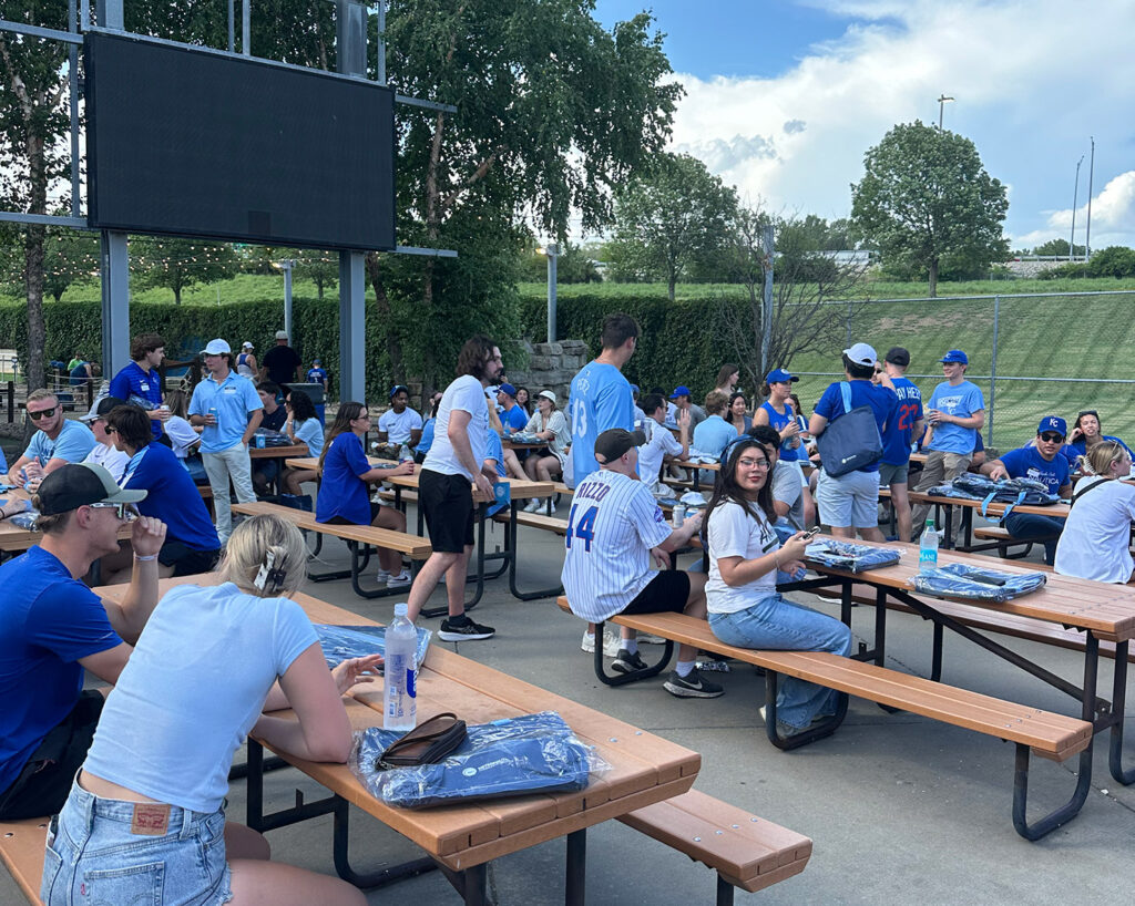 Interns mingle around picnic tables at Intern Night at the K. 