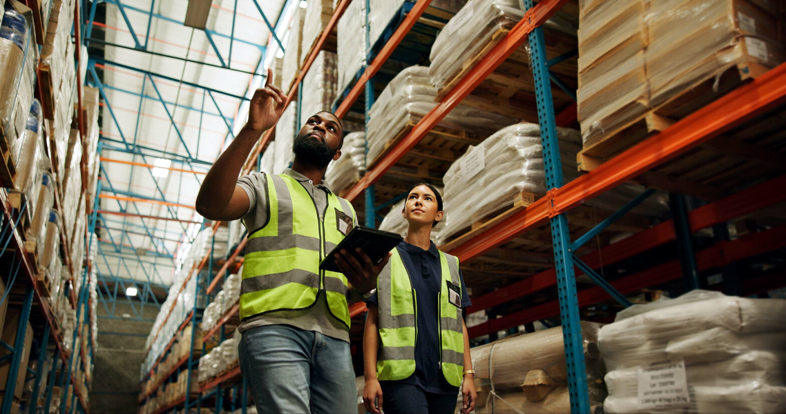 Two people walking around in an import warehouse