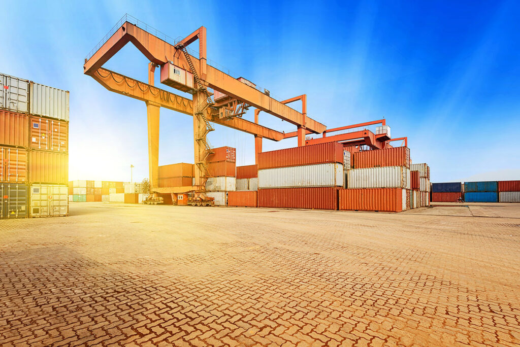 Containers and crane at sunset