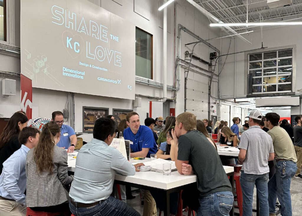 Interns gather around tables at the Share the Love KC event.