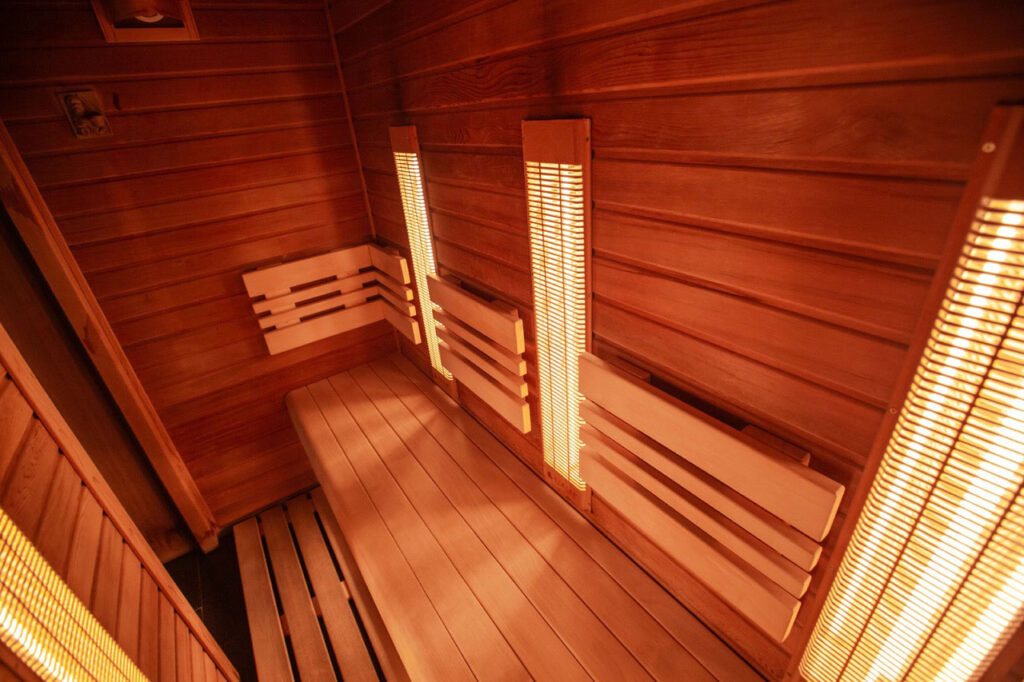 Empty spa room with wooden benches and walls
