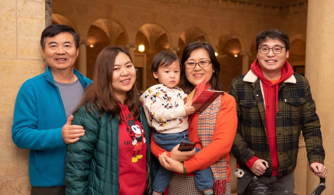 Family of Asian descent posed and smiling at the camera