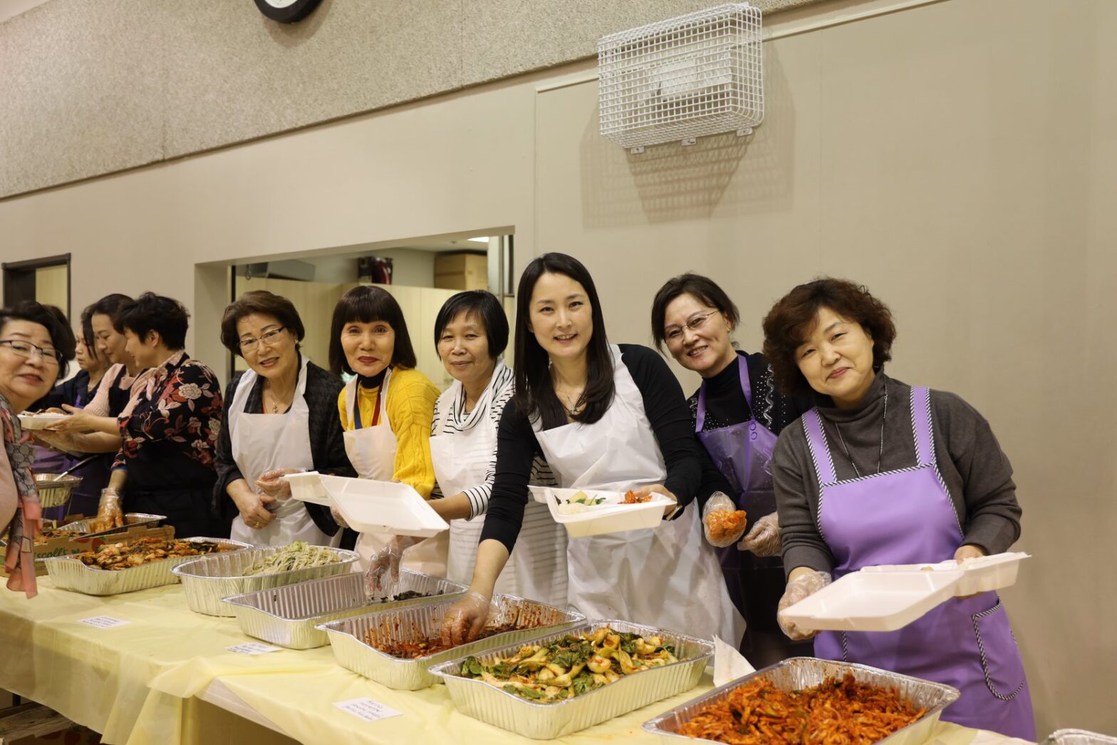 Korean women operate a buffet-style dinner serving.