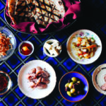 Spread of dishes on a blue tablecloth