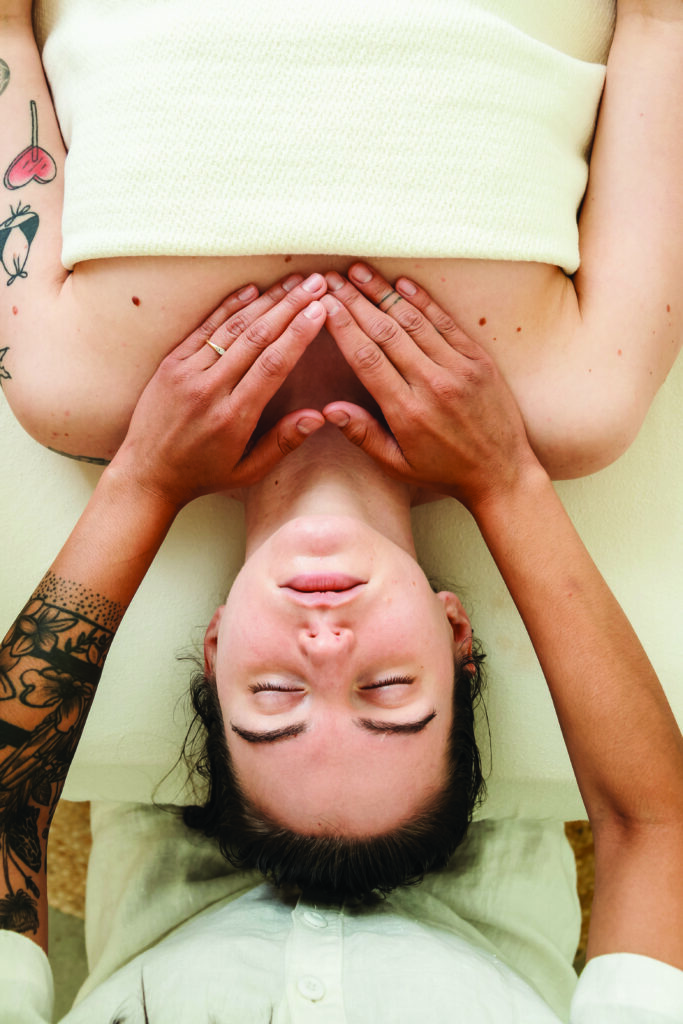 A woman on a massage table at Hand & Land. 