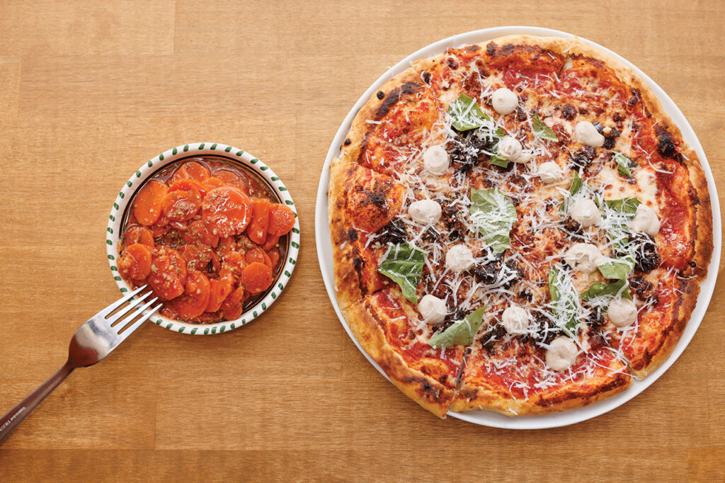 A pizza and carrot salad.