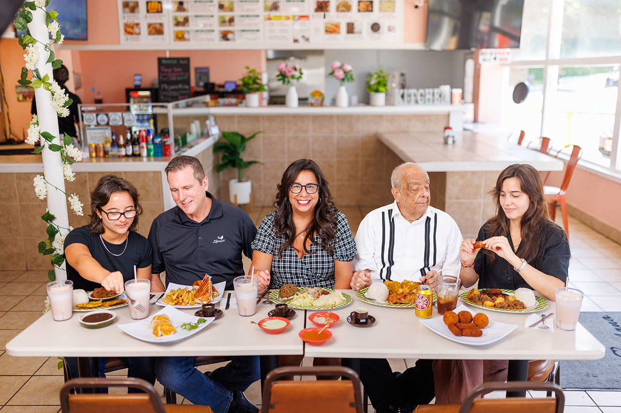 Noeida Kuhnert at a table with her four family members.