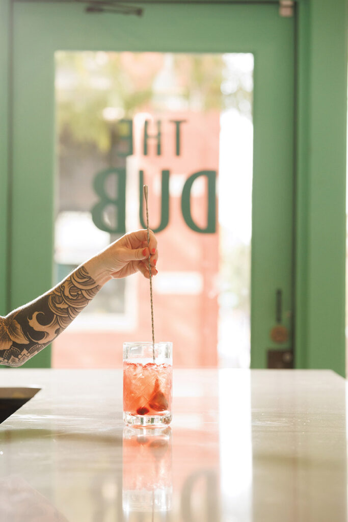 A bartender stirring a drink at The Dub. 