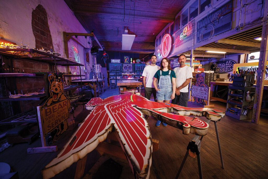 Dylan, Olivia and Randy standing in the Element Ten neon studio.