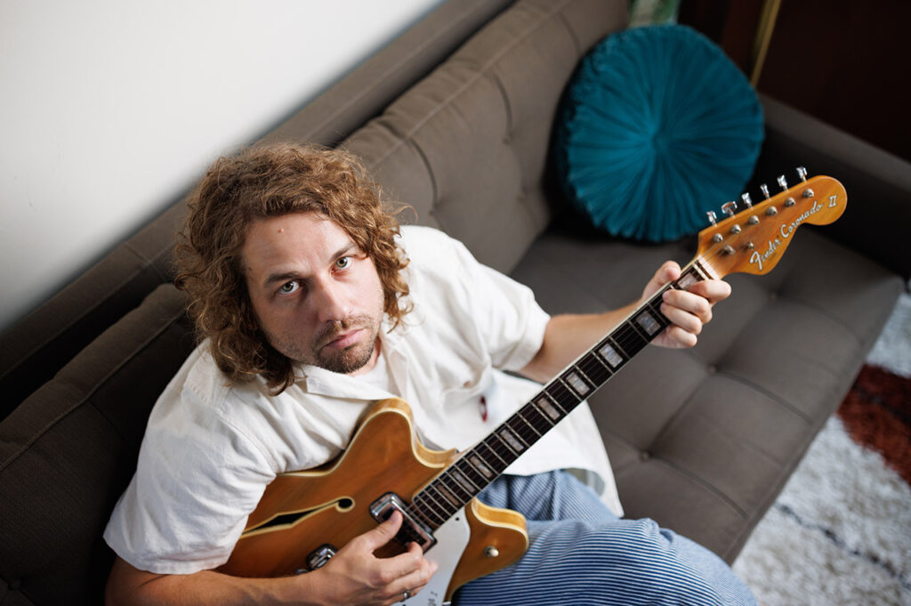 Kevin Morby playing guitar.