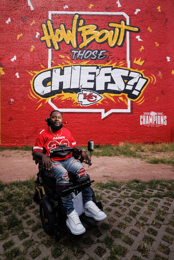 Will Smith in front a Chiefs mural. 