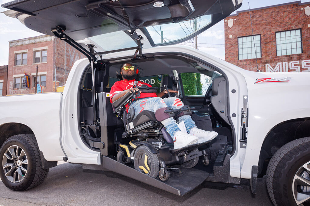 Will Smith, using the wheelchair lift in his truck. 