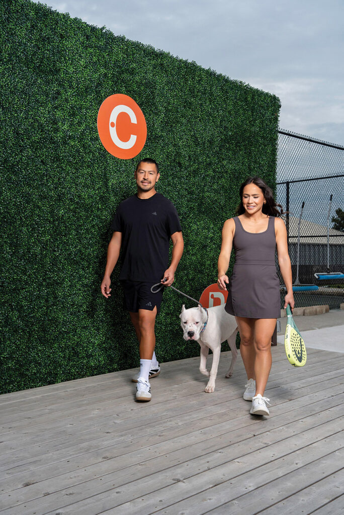 Lo'eau, with her husband Rodger and dog Amigo, walking into La Casa del Padel.