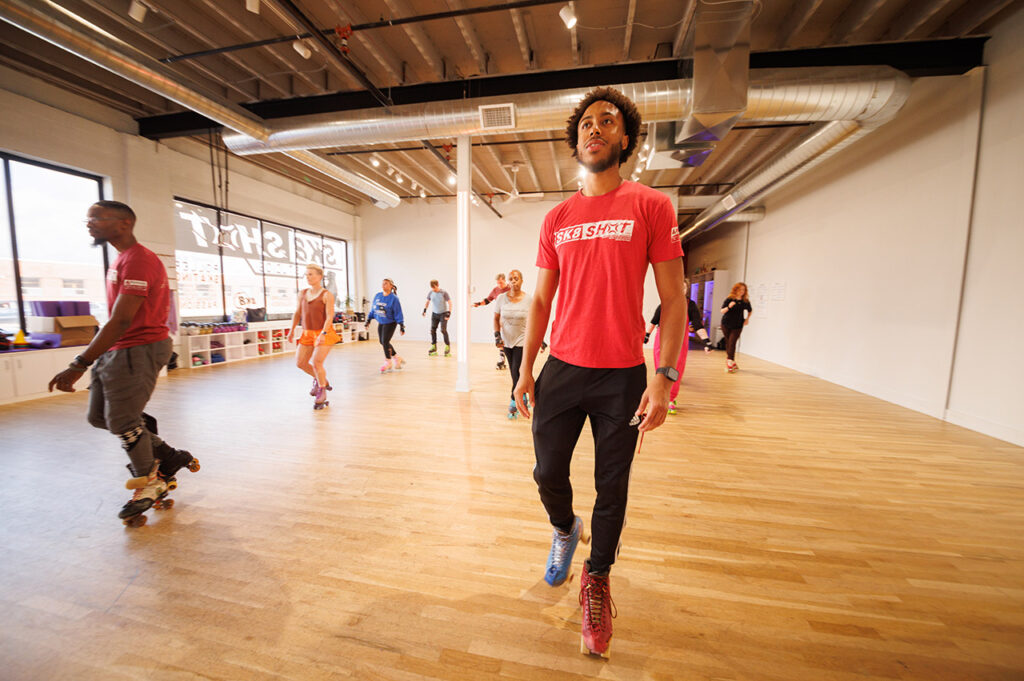 Knejie “KJ” Allen and Adontis Atkins teaching a skate class in studio.