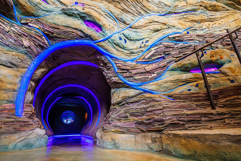 Artistic interpretation of a rabbit hole, going down a purple hallway