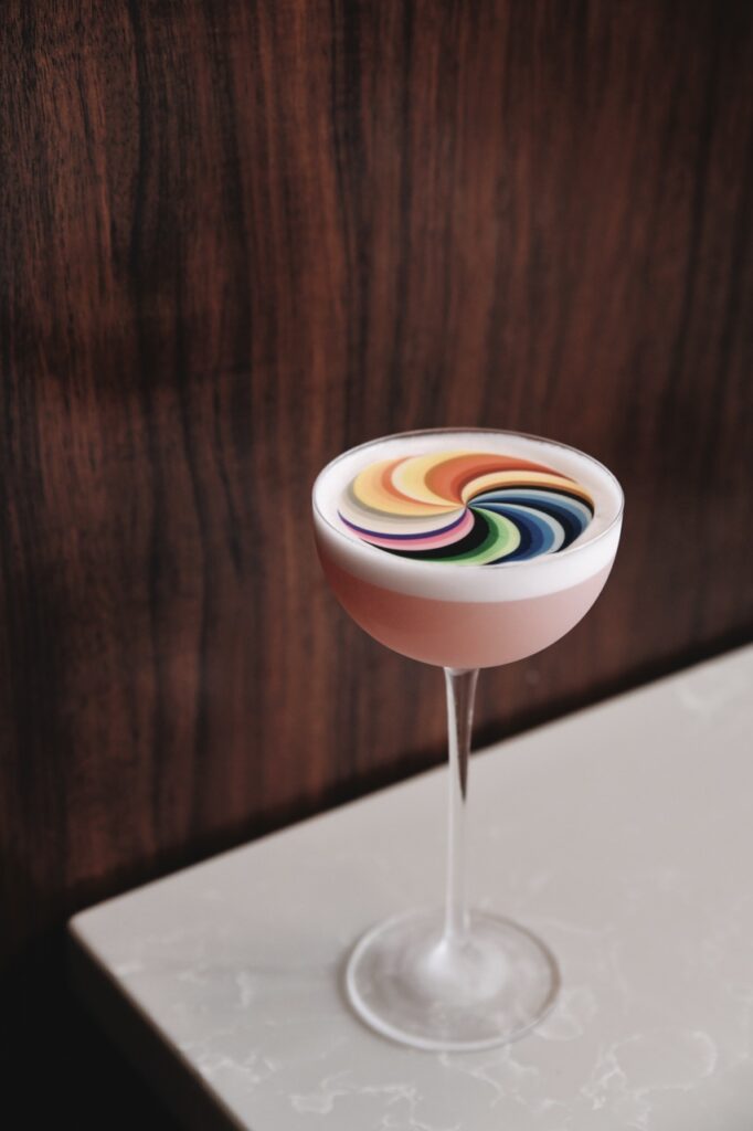 Cocktail glass with a rainbow swirl on top