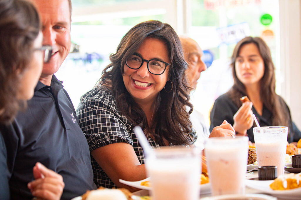 Noeida and family talking over lunch. 