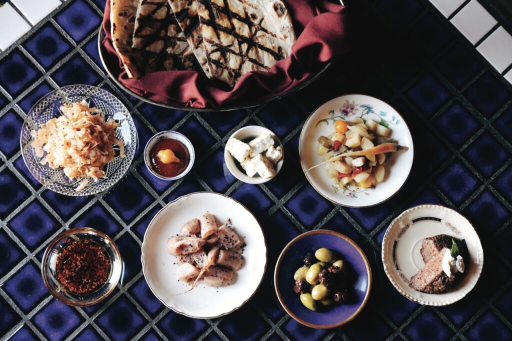 Spread of various small plates on a dark blue tablecloth