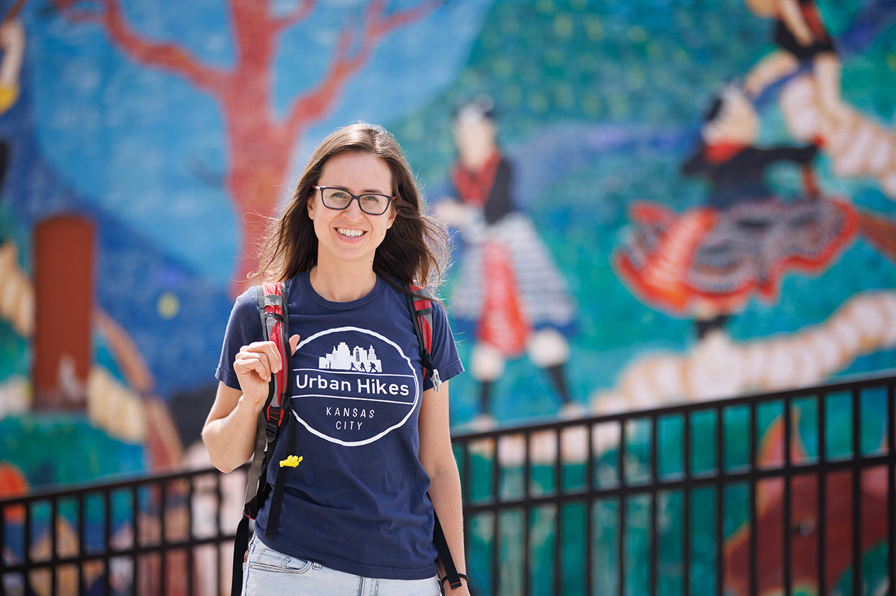 Lisa Pena in front of a mural.
