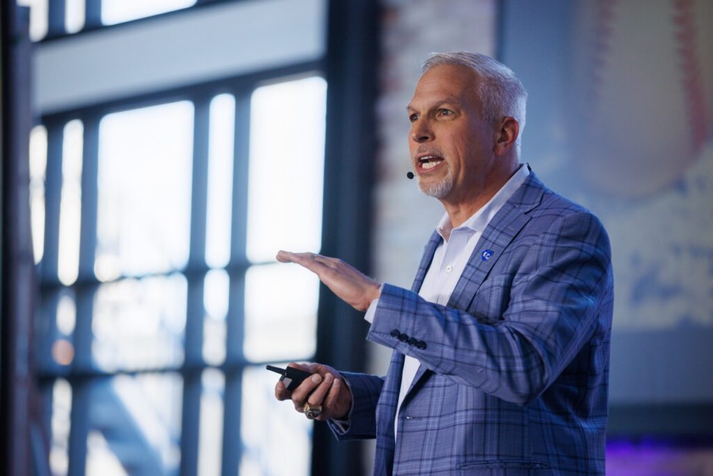 Man talks from stage. 