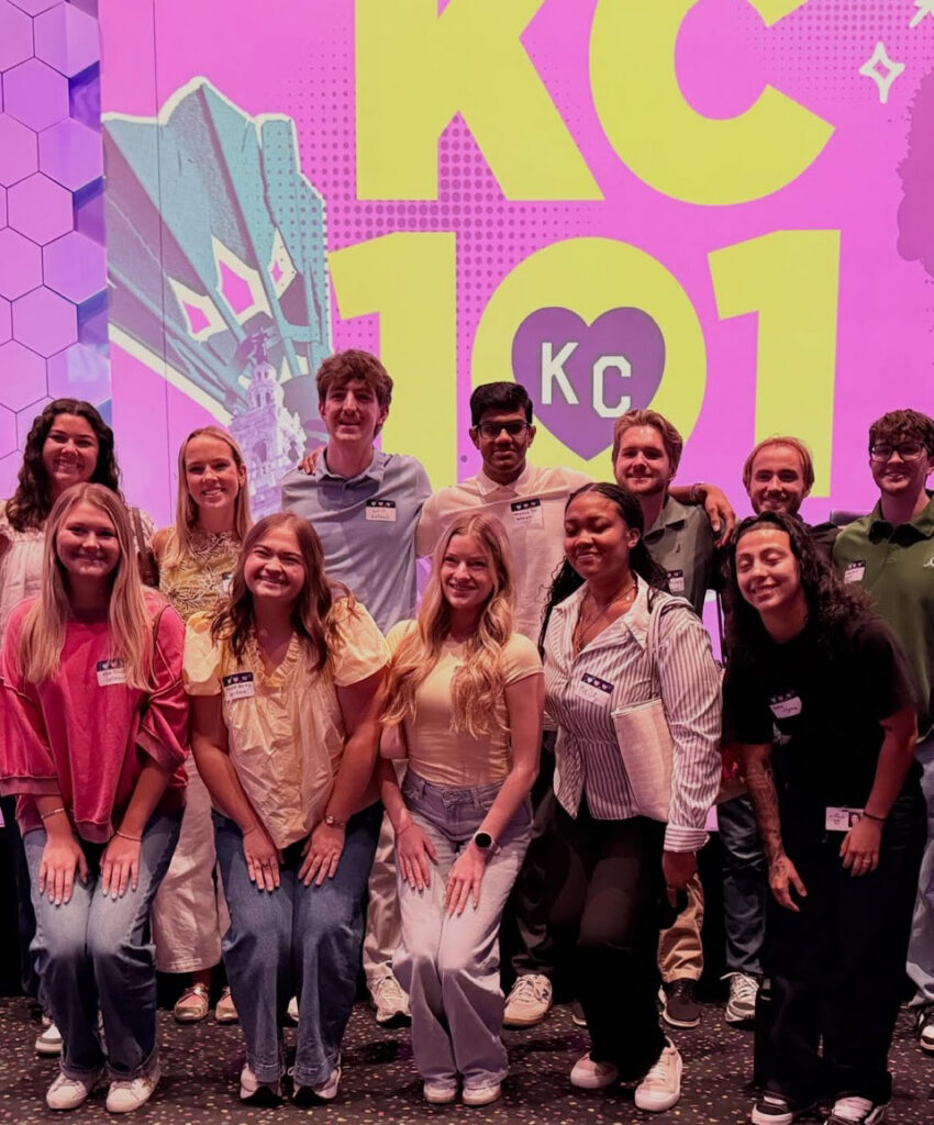 Group of interns standing in front of KC 101 screen